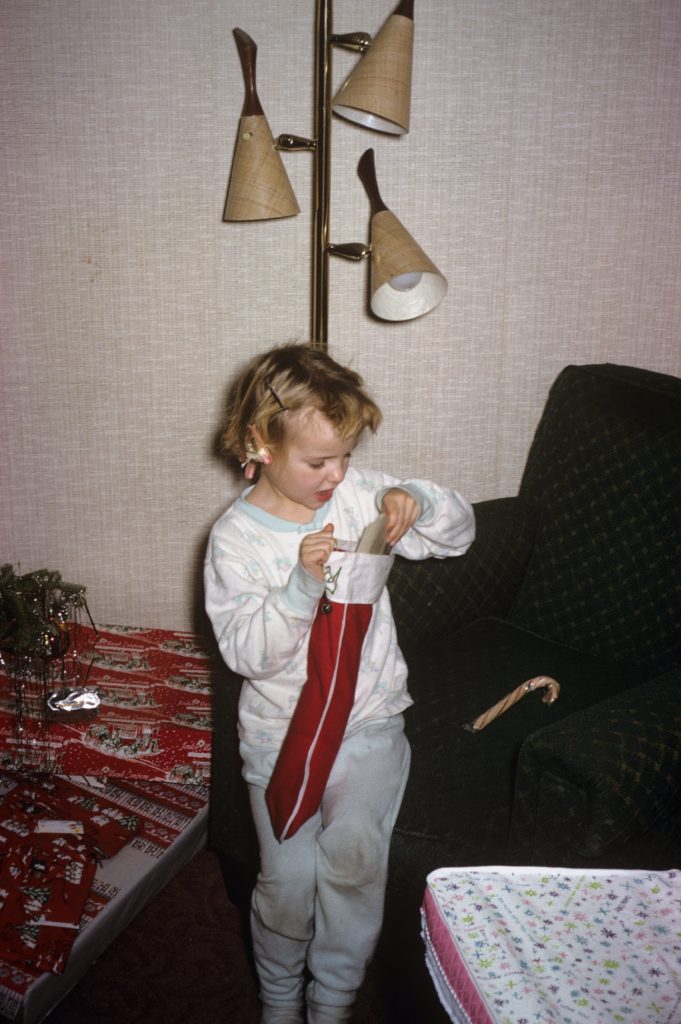 Photo of five year old opening her Christmas stocking
